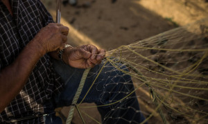 Fishermen mending net