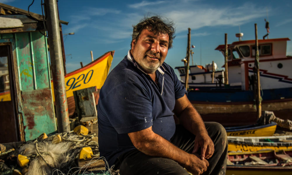 Fisherman sitting on dock